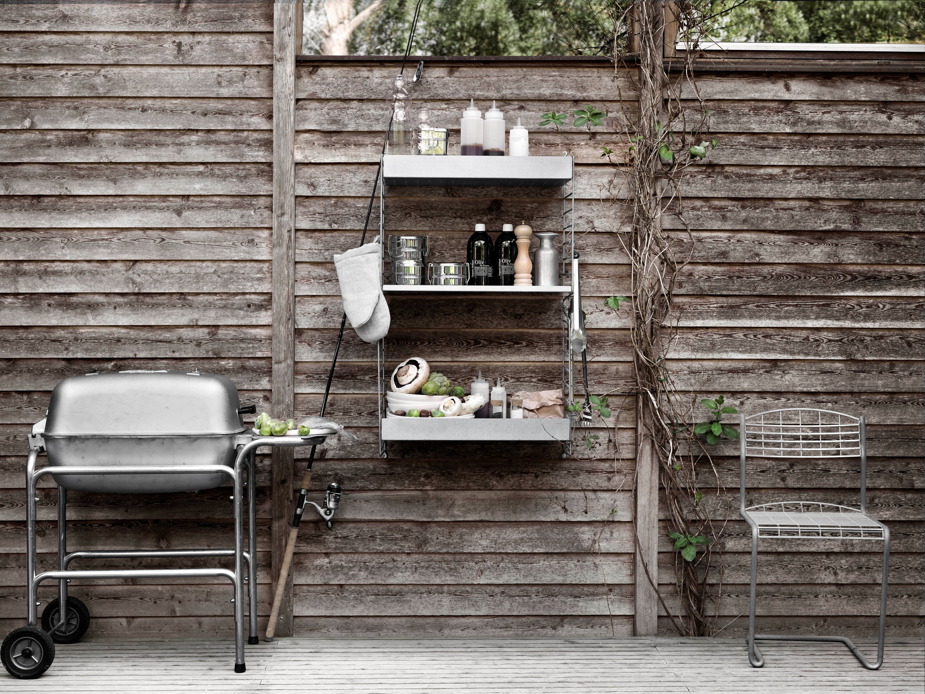 This wall-hung two-section combination is intended for outdoor use. With galvanized panels and shelves, the surface changes with time and leaves you with a beautiful patina. A combination of shelves with high and low edge gives the unit character.