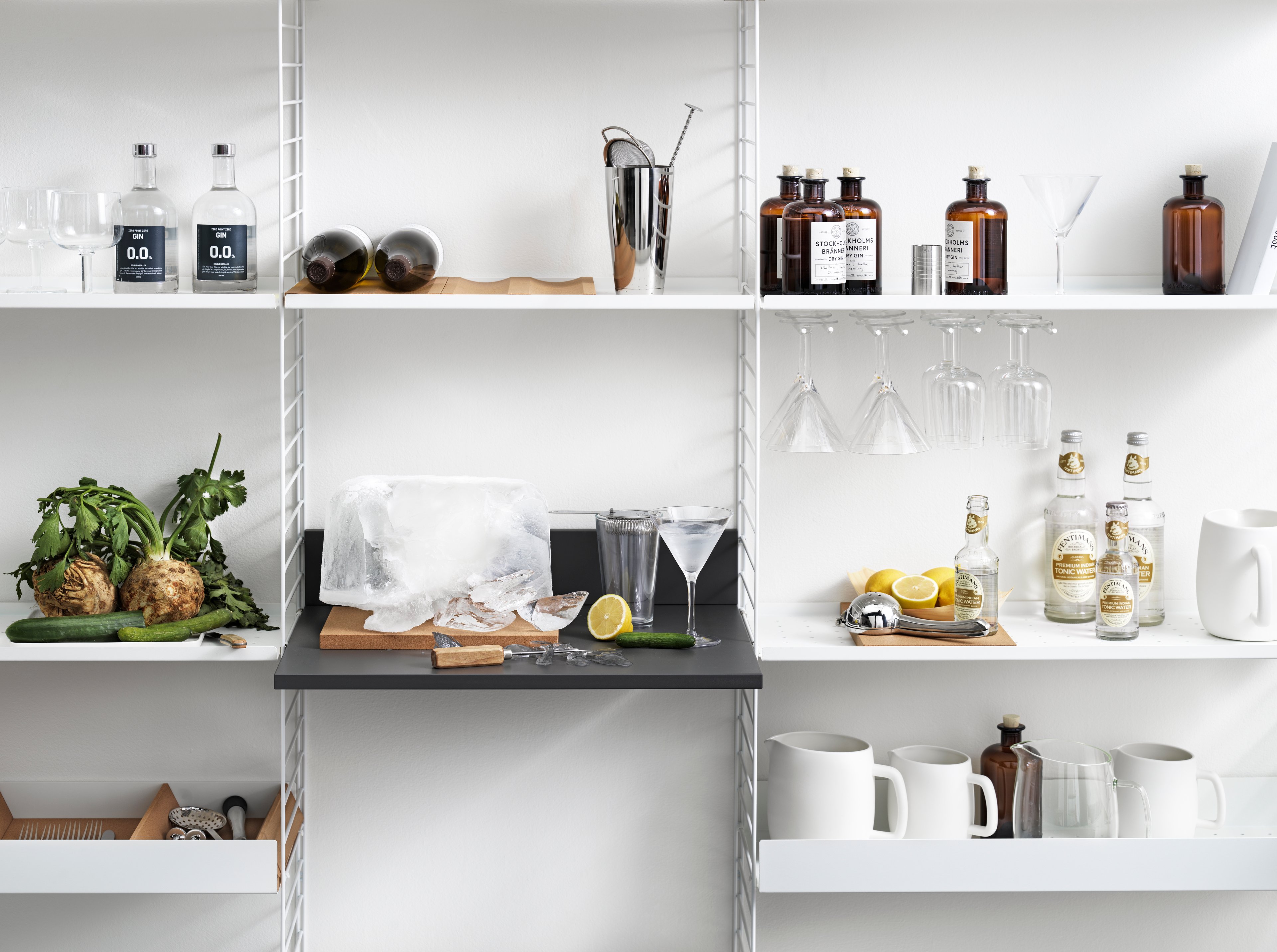 The media shelf is available in one size, b58 x d47 x h10 cm and fits into wire panels from String® System with depth 30 cm. The media shelf is produced to give the vinyl record player a designated spot. The media shelf is designed to help you organize all cords and cables by letting them disappear behind the shelf without the risk of getting pinched between the wall and shelf. The media shelf can easily be turned into a workspace, or why not a drink table. Each packaging contains one media shelf, one ledge to place against the wall to stabilize the media shelf along with brackets.