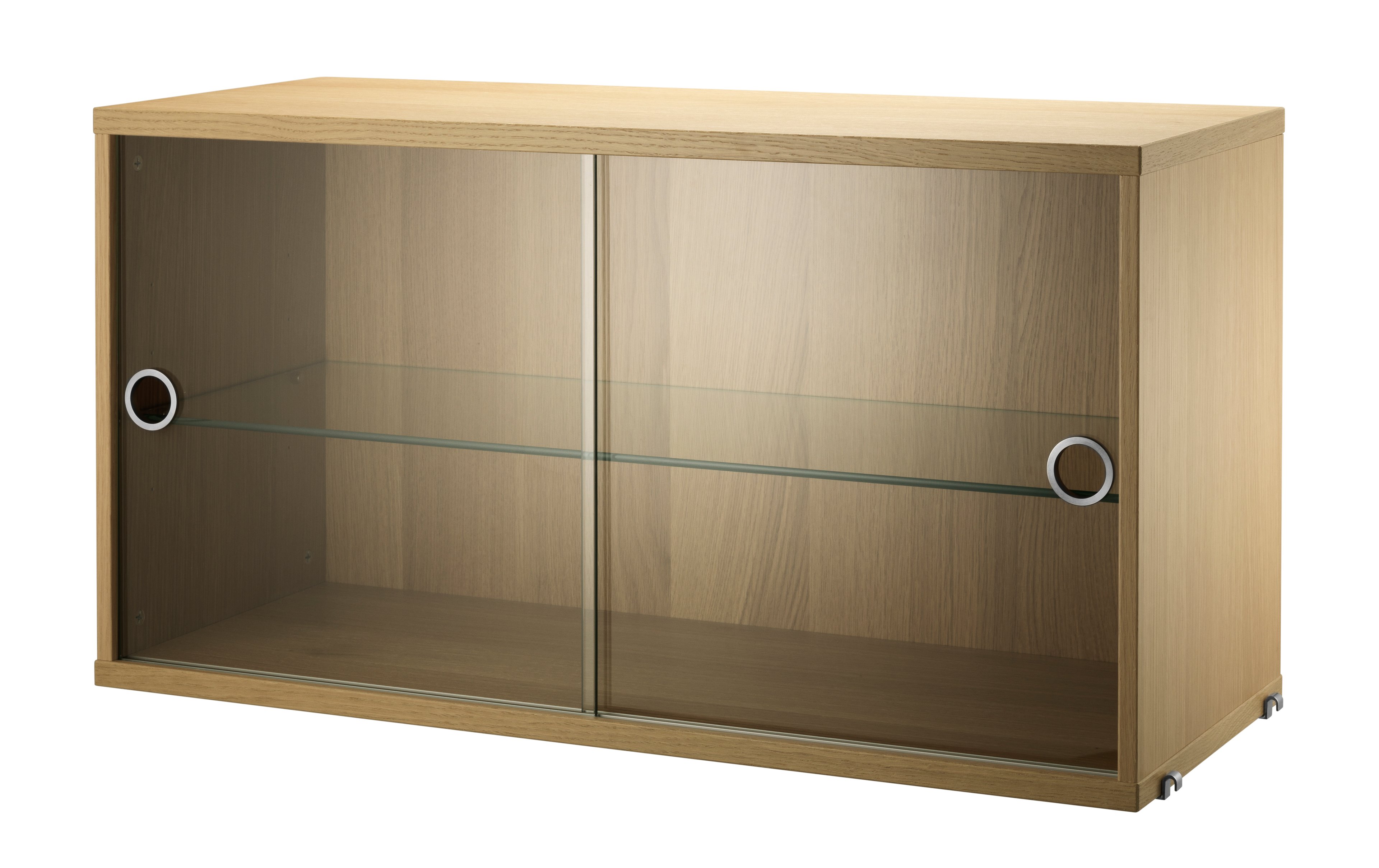 The display cabinet with sliding glass doors is available in one width, 78 cm, and one depth, 30 cm. The display cabinets fit into all wire panels from String® System if the depth of the panels is 30 cm. It is visually pleasing to add a bolder element to your shelf, like a cabinet, which also give you a lot of extra storage and the possibility to showcase something fragile. The display cabinet consists of one adjustable inner shelf in glass and the internal dimensions are: depth 26 cm, width 74 cm, and height 38 cm. The display cabinet is delivered unassembled.