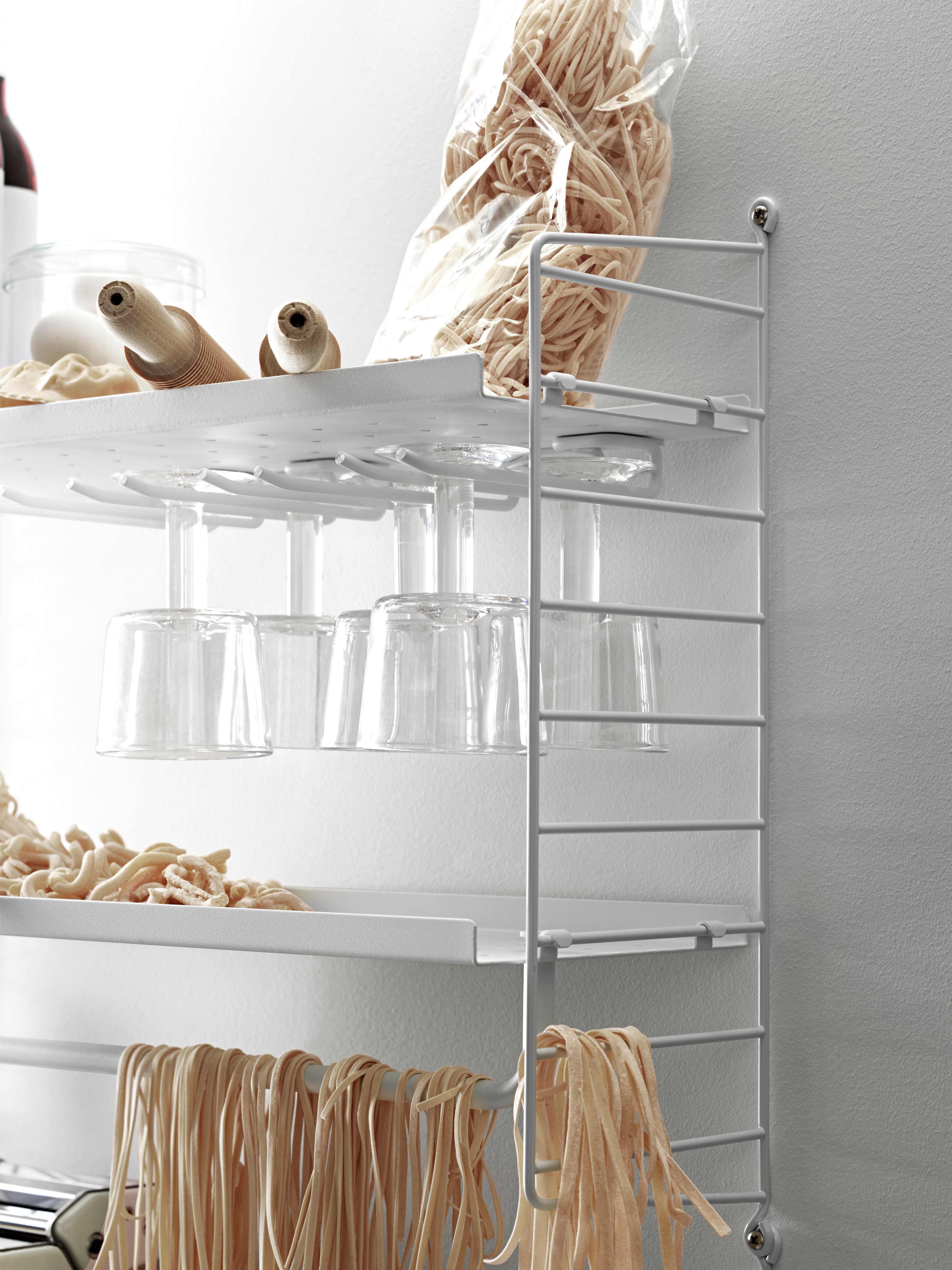 The hanger racks are created to optimize a shelving combination with metal or galvanized shelves. It is the optimal kitchen accessory, and it is available in two different sizes, 20 and 30 cm. Number of wine glasses (diameter of the rim: 7 cm) that fit on 20 cm deep hanger racks are 2-3, and 3-4 on 30 cm deep hanger racks. A 58 cm wide metal shelf can fit up to three hanger racks and a 78 cm wide can fit up to four. Each packaging contains two hanger racks, where each hanger rack has two sets of rails.
