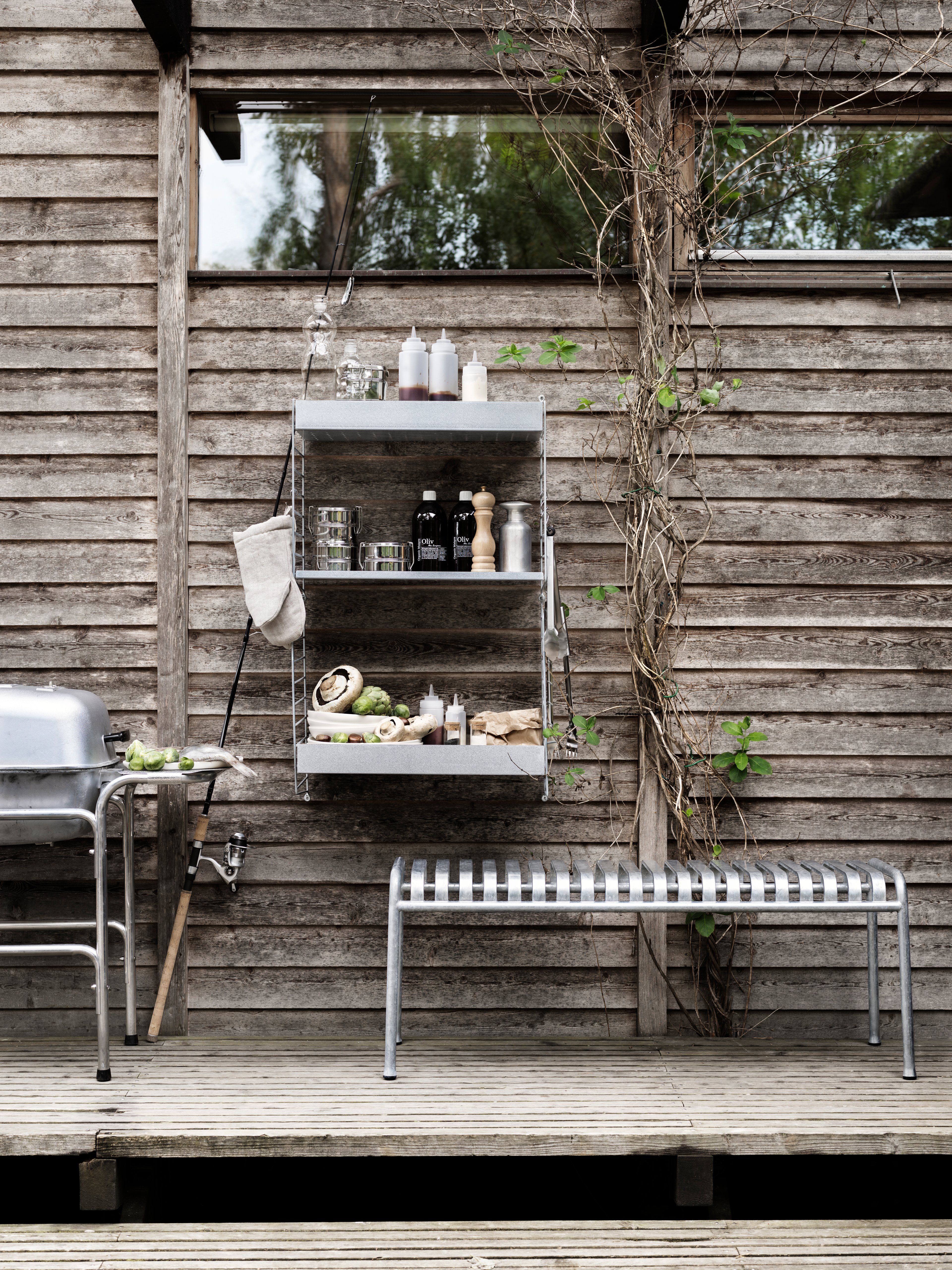 This wall-hung two-section combination is intended for outdoor use. With galvanized panels and shelves, the surface changes with time and leaves you with a beautiful patina. A combination of shelves with high and low edge gives the unit character.