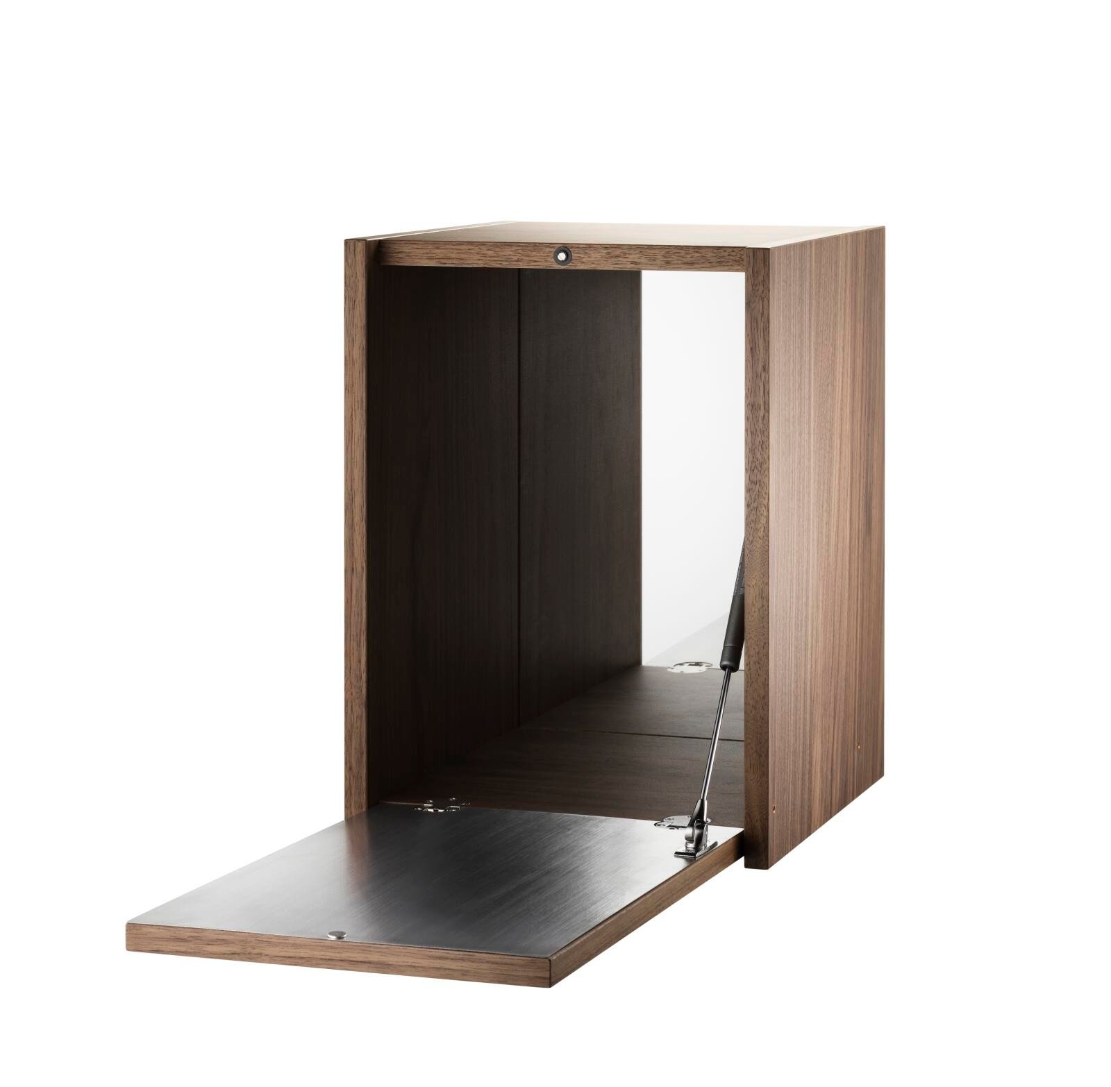 The Tiny cabinet is available in one size with the following dimensions: w28 x d30 x h38 cm. The cabinet fits together with all 30 cm deep wire panels from String® System. The cabinet needs to be placed on top of either a wooden shelf or one of our cabinets and attached to either wire panel. The inside of the lid is dressed in a plate in brushed stainless steel. The inner back wall of the cabinet is dressed in a mirrored plate. The cabinet is delivered unassembled.