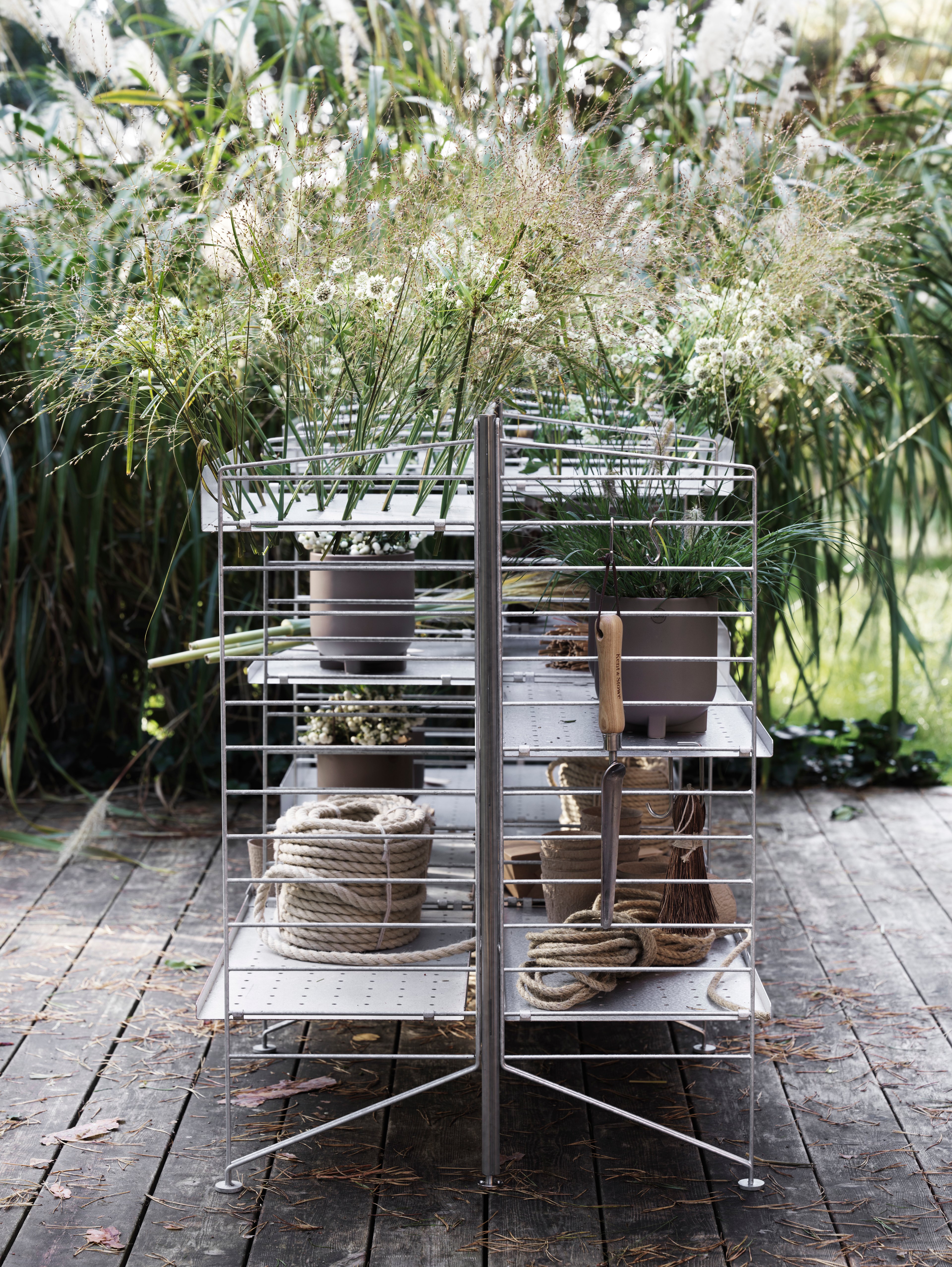 Free standing galvanized shelf intended for outdoor use. This smaller one section combination is optimized with shelves on either side of the shelf. A mix of galvanized metal shelves with high and low edge give the shelf character and further storage possibilities. The galvanized material changes over time and leaves you with a beautiful patina.