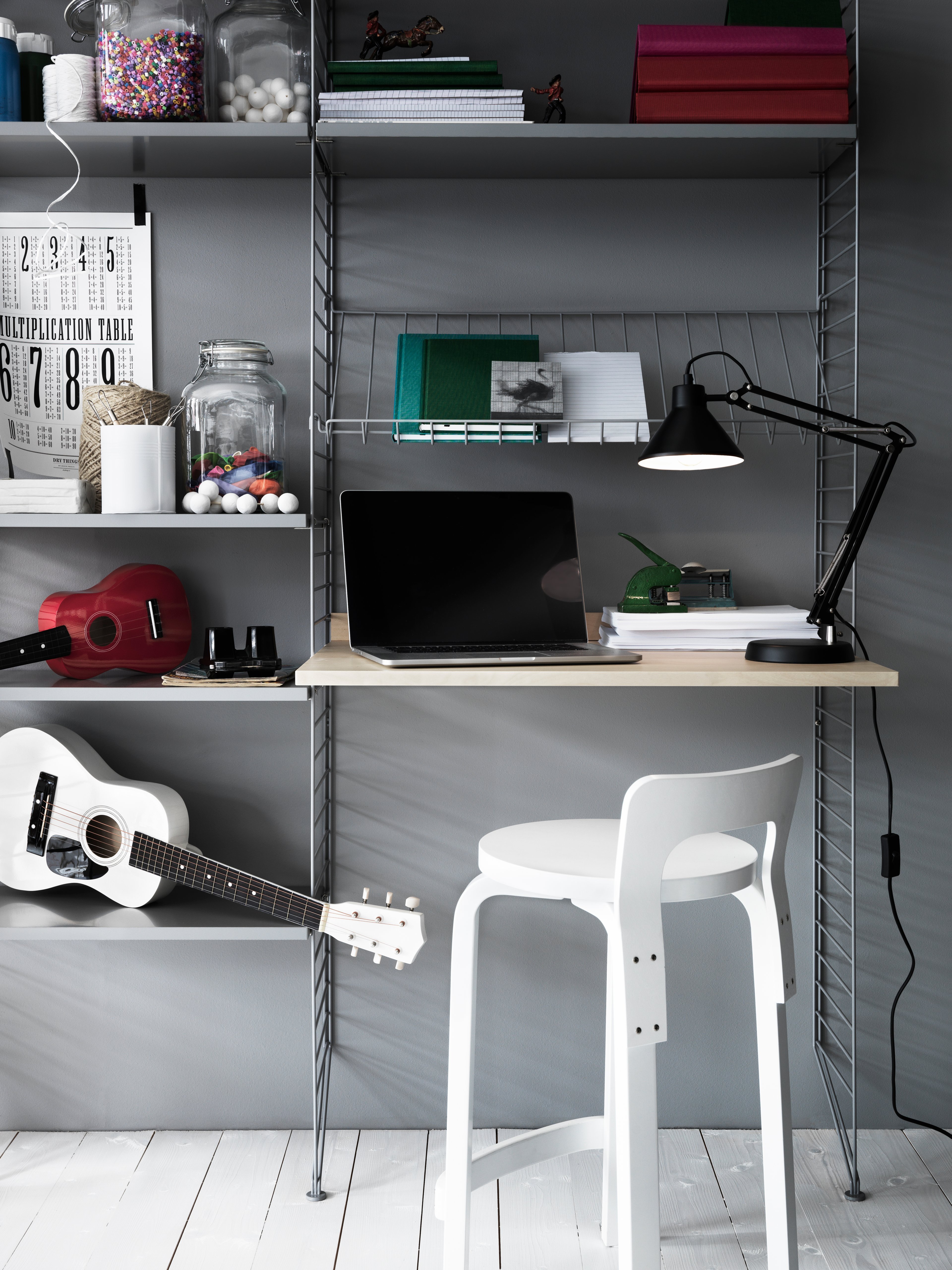 The work desk is available in one size, 78x58 cm and fits into wire panels from String® System with depth 30 cm. The work desk can easily be adjusted to your preferred height and can be used in an office, kitchen, hallway, or any other room where you might have the need for an additional table. Make your workspace complete by mounting a works drawer underneath the work desk where you can store pens, notebooks, and such. Each packaging contains one work desk, one ledge to place against the wall to stabilize the work desk along with brackets. Choose among different colours and wood types.