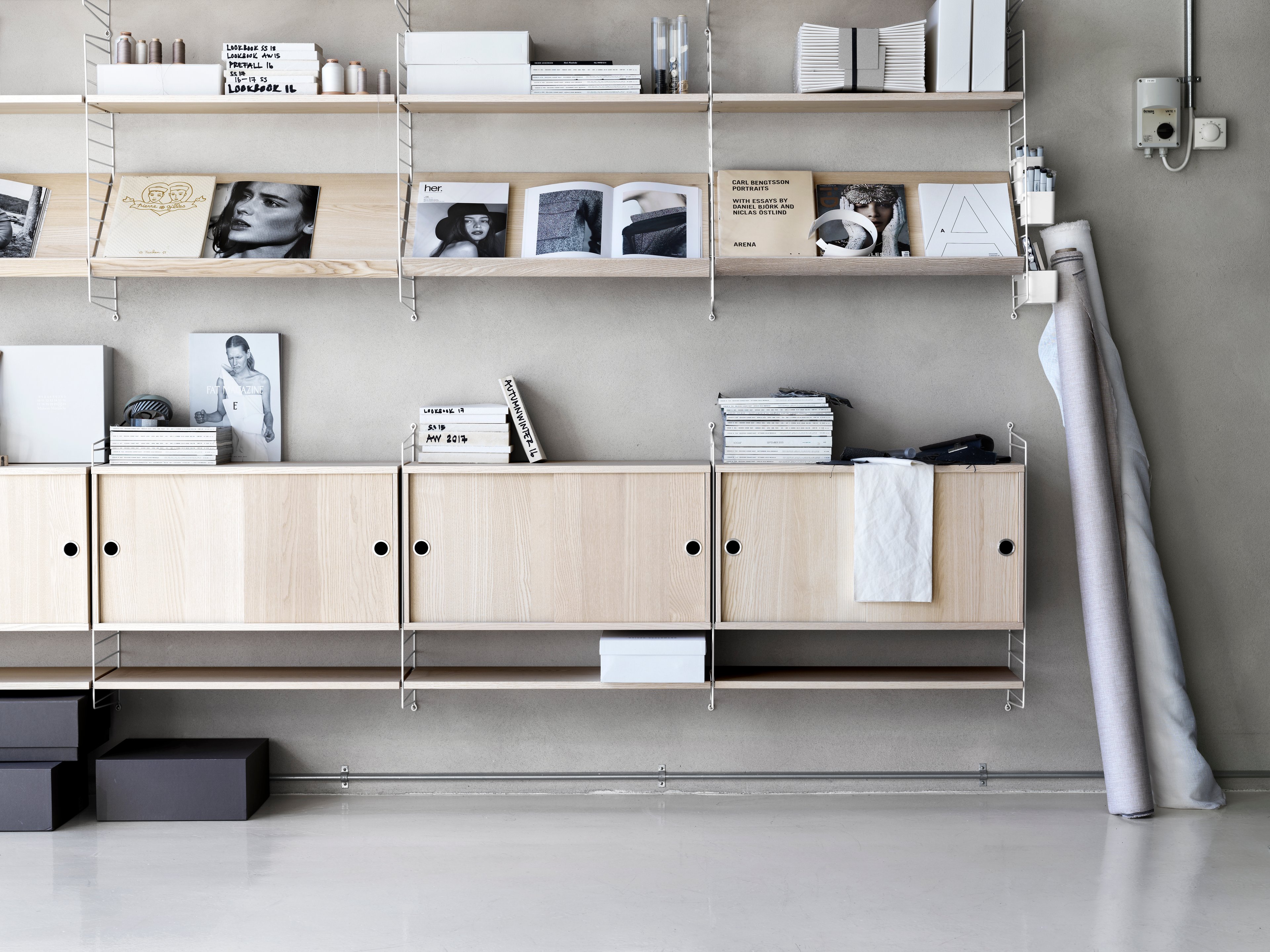The cabinets with sliding doors are available in one width, 78 cm, along with two depths, 20 and 30 cm. The cabinets fit into all wire and plex panels from String® System. It is visually pleasing to add a bolder element to your shelf, like a cabinet, which also give you a lot of extra storage. The cabinet consists of one divider placed in the middle along with two adjustable inner shelves. The cabinet’s inner dimensions are 4 cm less than the outer dimensions. The cabinets are delivered unassembled.