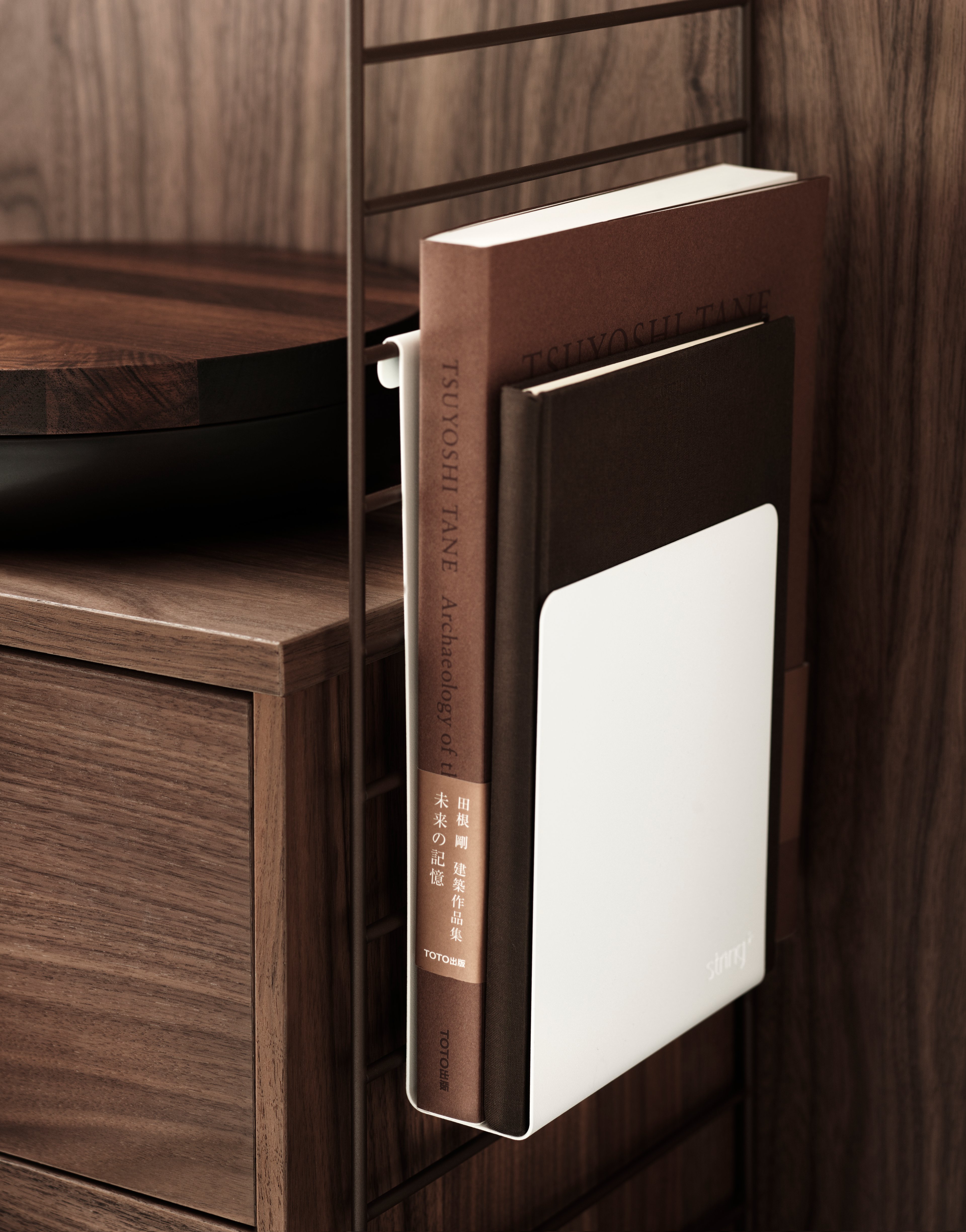 The magazine holder fits together with 20 and 30 cm deep wire panels from String® System. The magazine holder is design to increase functionality and to inspire new and creative storage solutions. Add it to your kitchen shelf to keep your food magazines in one place or add it to your living room combination to always have close proximity to your book when relaxing in your reading corner.