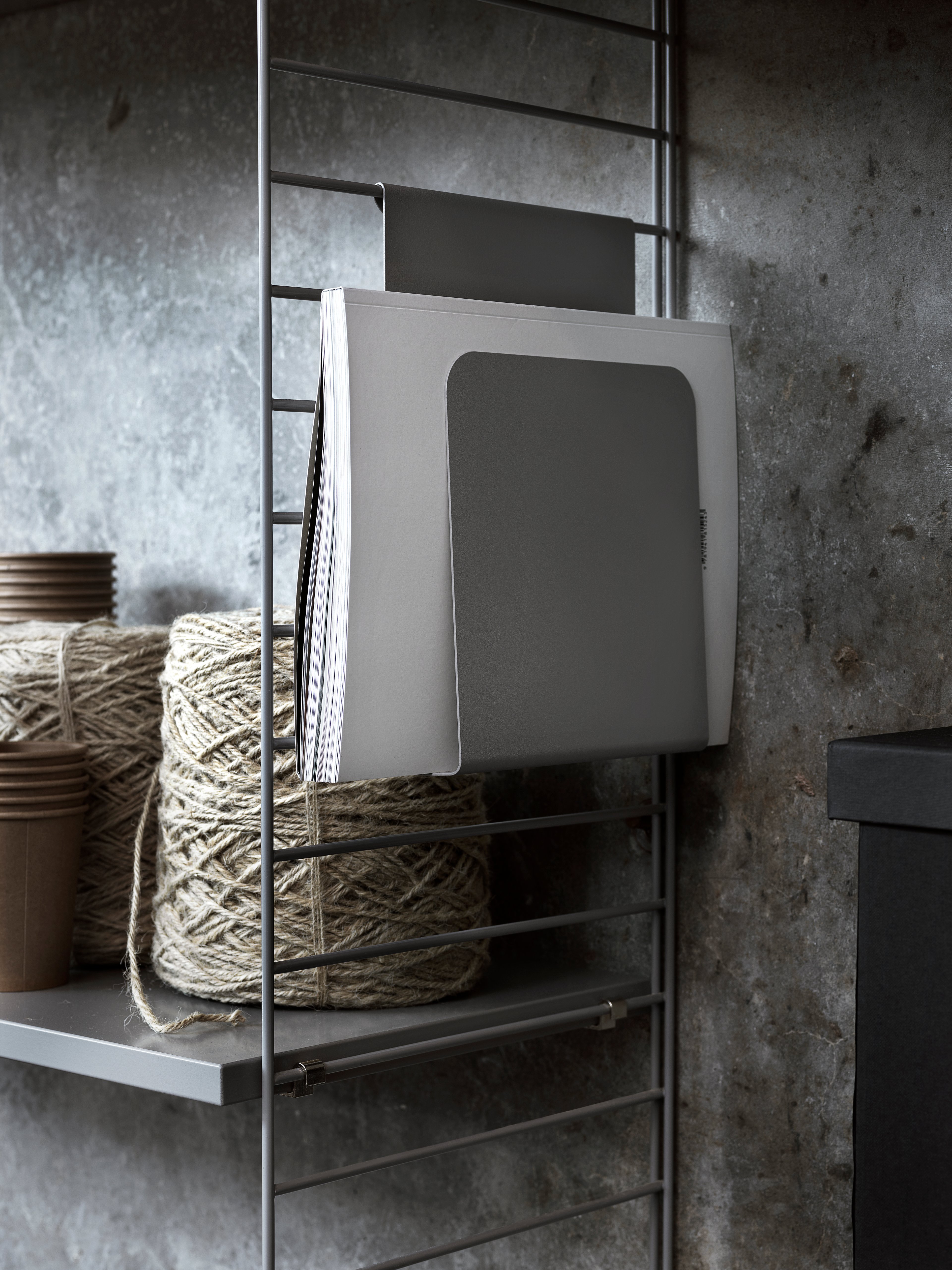 The magazine holder fits together with 20 and 30 cm deep wire panels from String® System. The magazine holder is design to increase functionality and to inspire new and creative storage solutions. Add it to your kitchen shelf to keep your food magazines in one place or add it to your living room combination to always have close proximity to your book when relaxing in your reading corner.