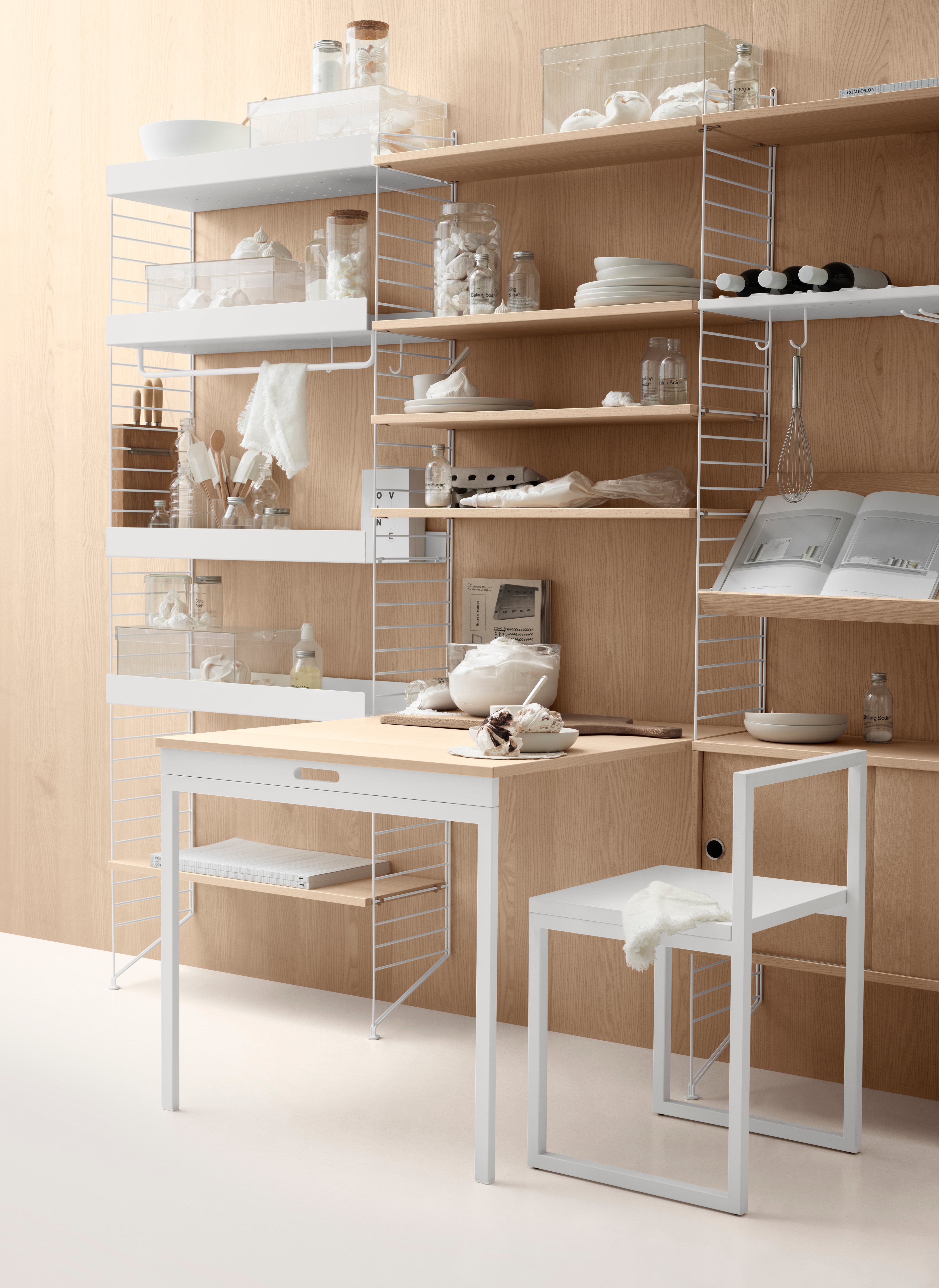 The folding table can be folded up and down with ease due to its flexible construction. The dimensions when folded up: w78 x d96 x h71 cm. When folded down the table melts into the shelf and then has the following dimensions: w78 x d30 x h71 cm. The folding table fits into 30 cm deep wire floor panels from String® System. The folding table is well suited for a smaller kitchen or other narrow spaces where a permanent table would be in the way. Maximize the usage and let the folding table act as your workspace during the day and dinner table at night.