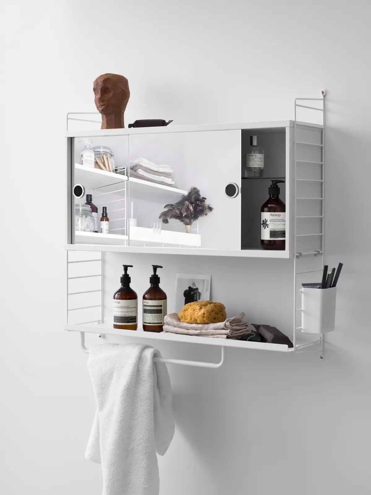 The cabinet with sliding mirror doors is available in one width, 78 cm, and one depth, 20 cm. The cabinet fits into all 20 cm deep wire and plex panels from String® System. The cabinet is great to add into your bathroom combination. The sliding mirror doors are smooth to slide to either side and perfect to store toothbrushes and other toiletries you do not want out in the open. The display cabinet consists of one adjustable inner shelf in glass. The cabinet has internal dimensions: w74 x d16 x h33 cm. The cabinet is delivered unassembled.