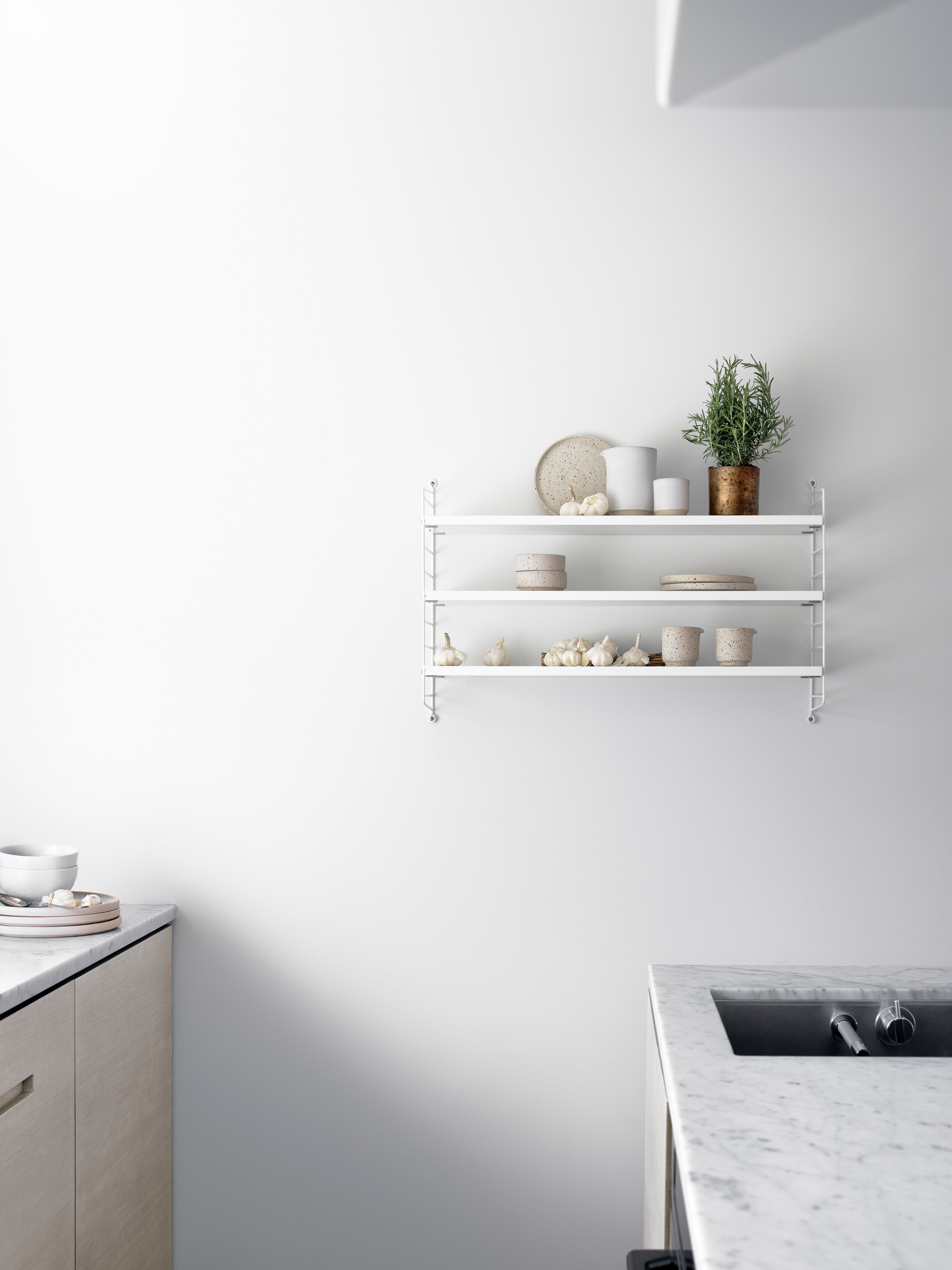 The wall panels are available in two heights, 50 and 75 cm, along with two depths, 20 and 30 cm. The panels are the base when building your string shelf. When the panels are decided you can start adding products from String® System. Choose among different shelves and cabinets. The wall panels are mounted onto a wall and do not touch either the floor or ceiling, which makes the whole shelf easy to adapt to any room. Make your shelf even more functional and unique by adding organizers or hooks, which all are placed on the panel’s threads. The panels come in two different packaging’s, either with one wall panel or two wall panels.