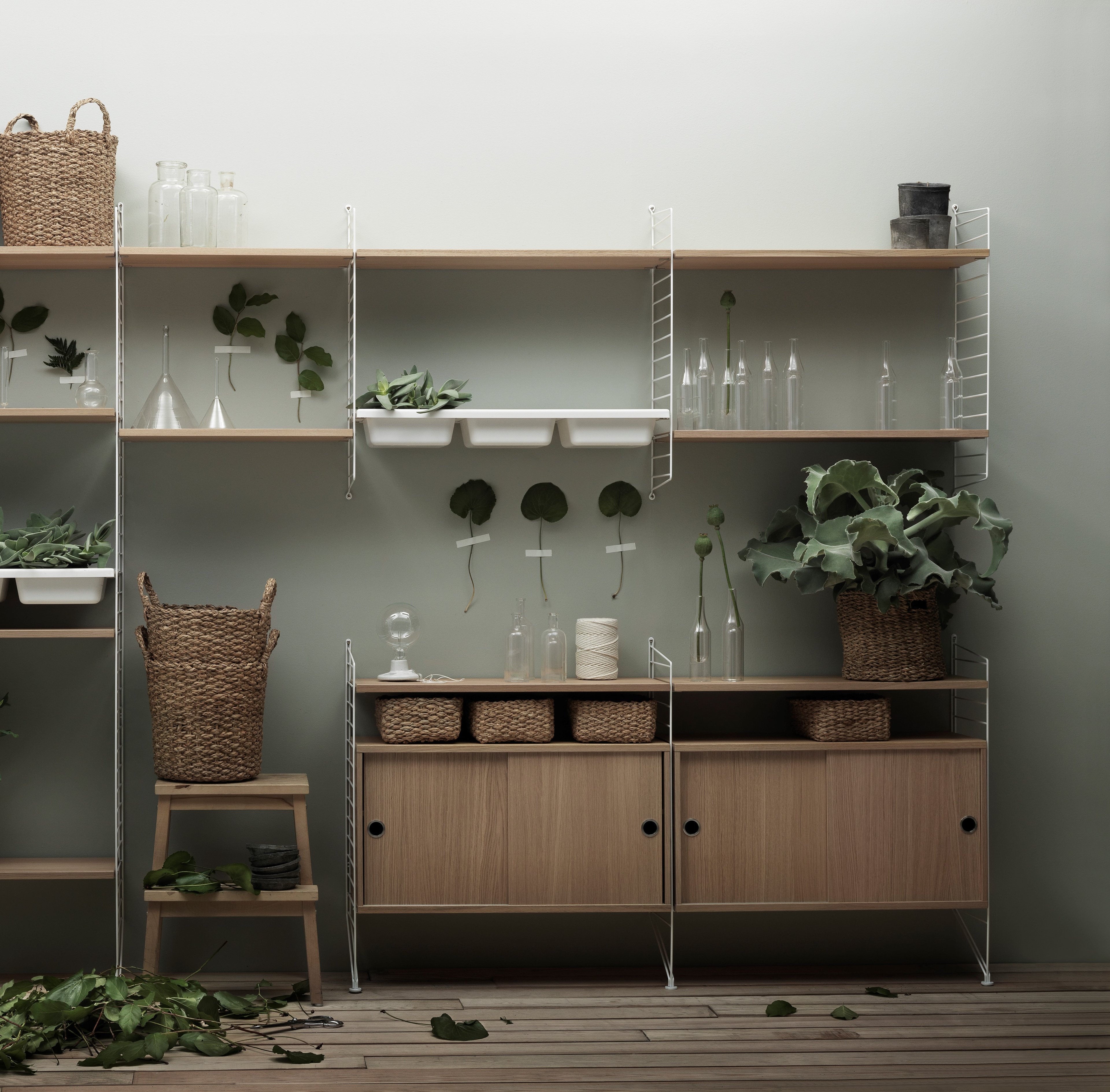 The cabinets with sliding doors are available in one width, 78 cm, along with two depths, 20 and 30 cm. The cabinets fit into all wire and plex panels from String® System. It is visually pleasing to add a bolder element to your shelf, like a cabinet, which also give you a lot of extra storage. The cabinet consists of one divider placed in the middle along with two adjustable inner shelves. The cabinet’s inner dimensions are 4 cm less than the outer dimensions. The cabinets are delivered unassembled.